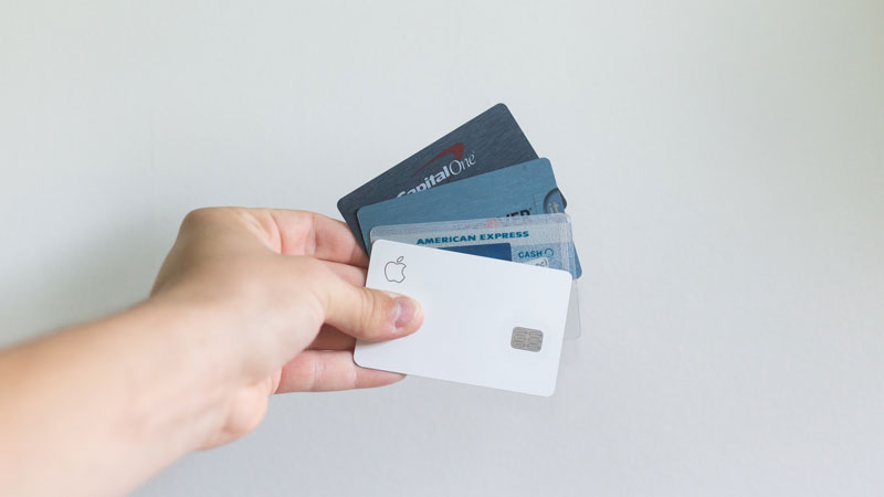 A person holding several credit cards.